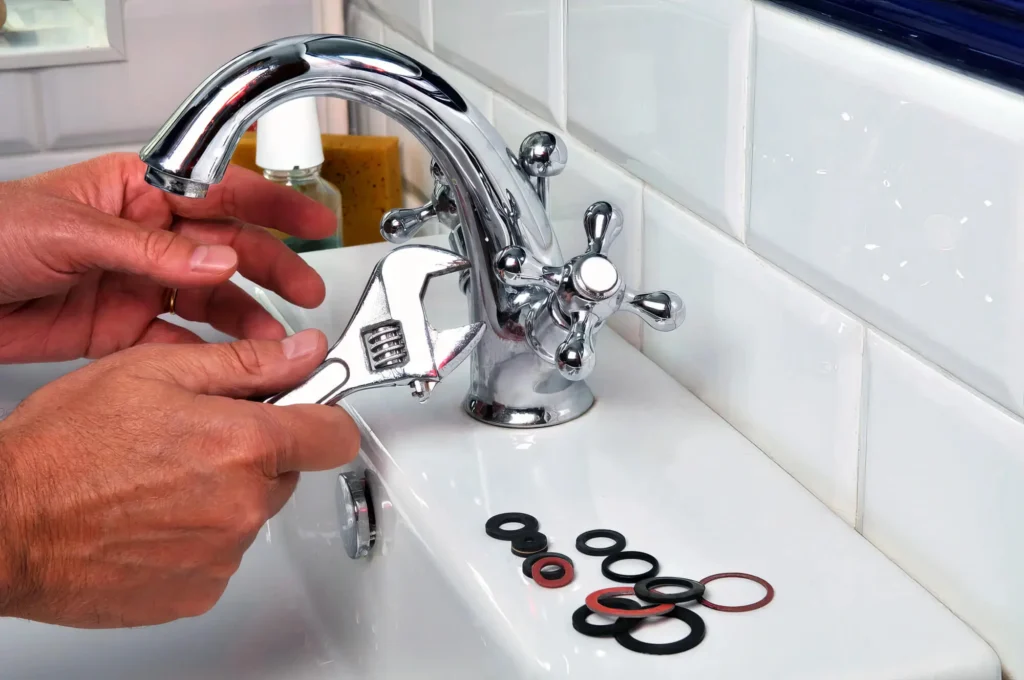 Plumber performing maintenance on a bathroom faucet in Valrico