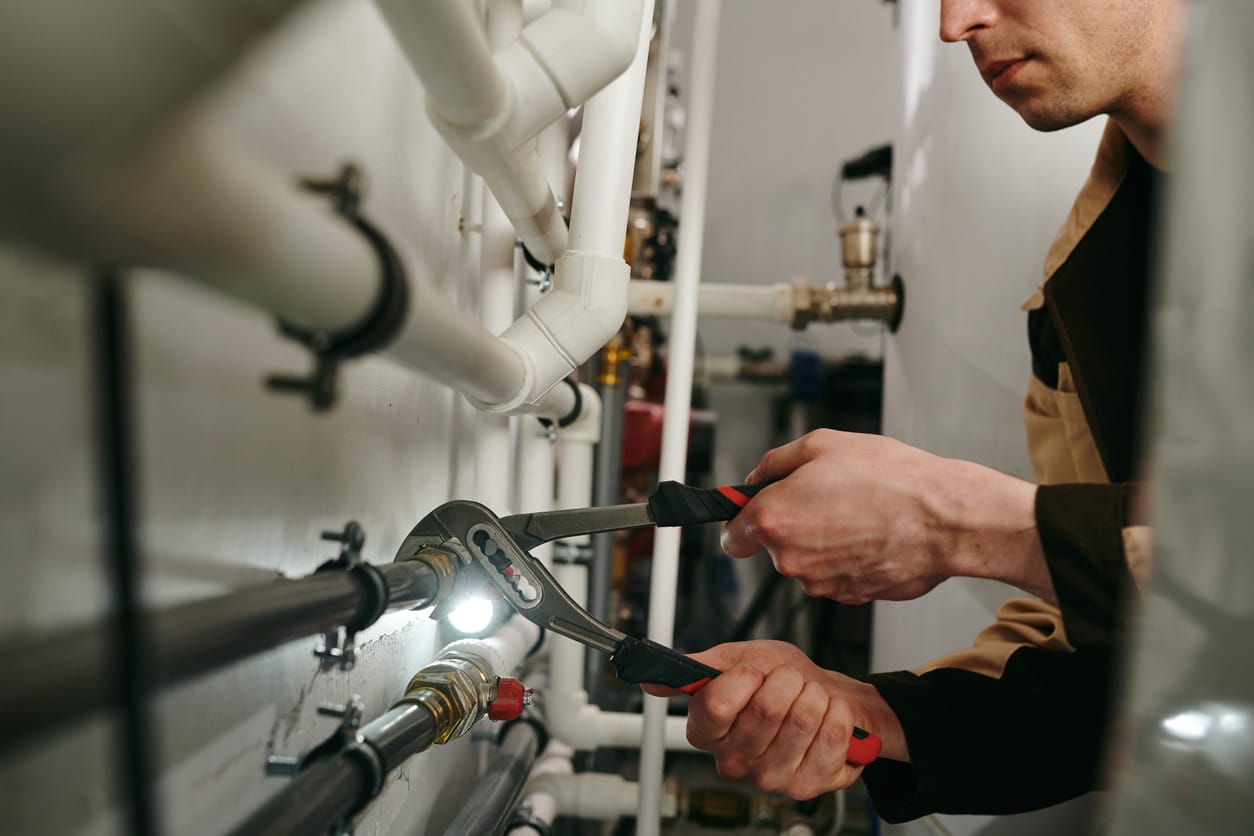 Plumbers maintaining commercial plumbing pipes in Valrico