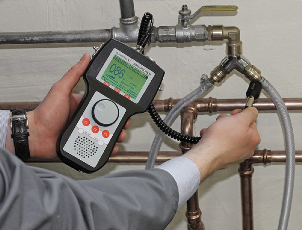Plumber testing pipes with electronic leak detection equipment in Valrico