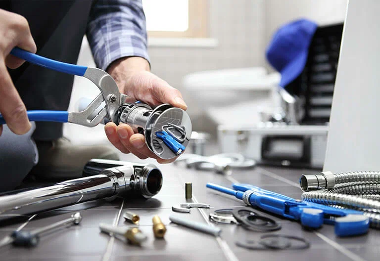 Technician repairing a plumbing fixture with professional tools in Valrico