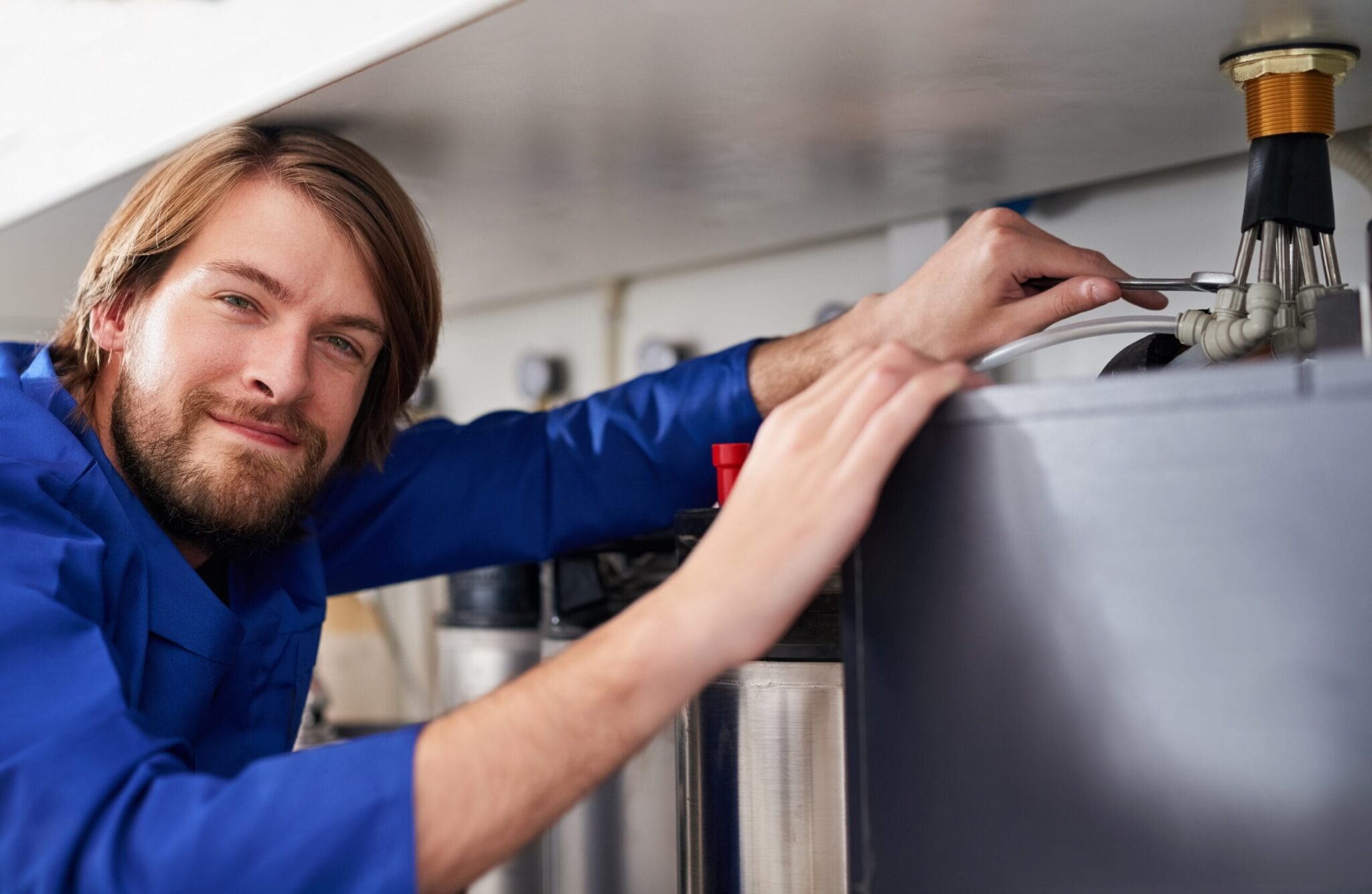 Technician servicing a residential water heater tank in Valrico