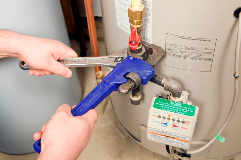 Plumber repairing a water heater valve in Valrico